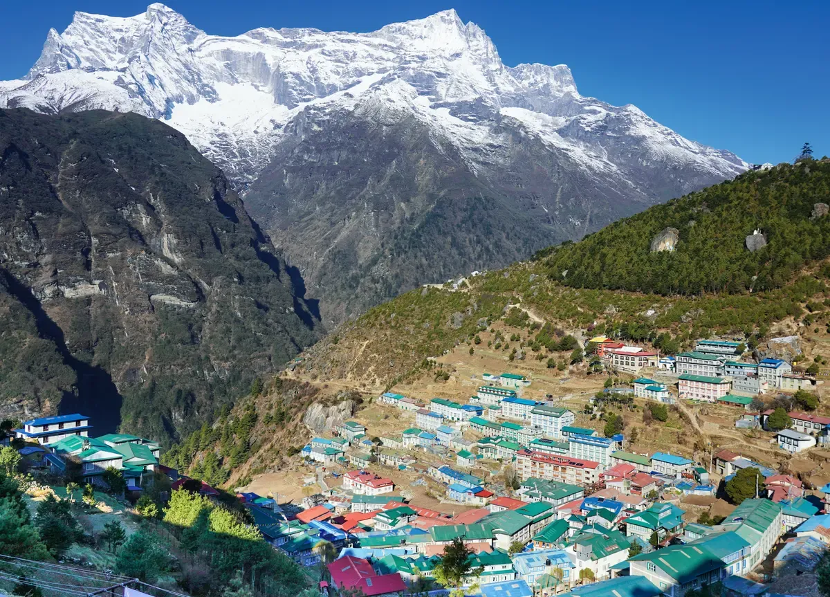 Namche Bazaar on its horseshoe slope below Kongde Ri, the acclimatisation stop on Everest climbing tours and base camp treks